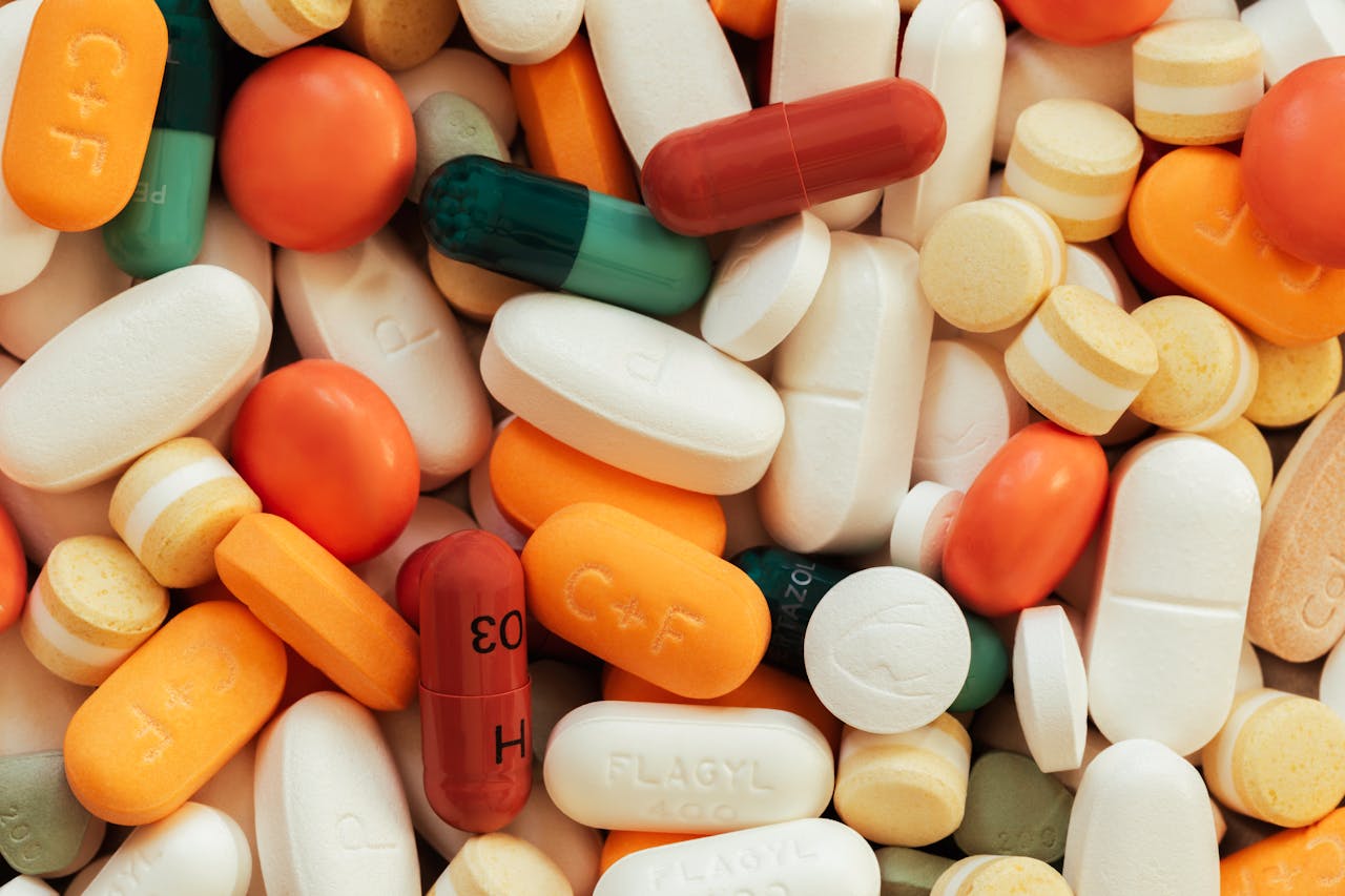 who-we-are Close-up of assorted colorful pills and tablets on a surface.